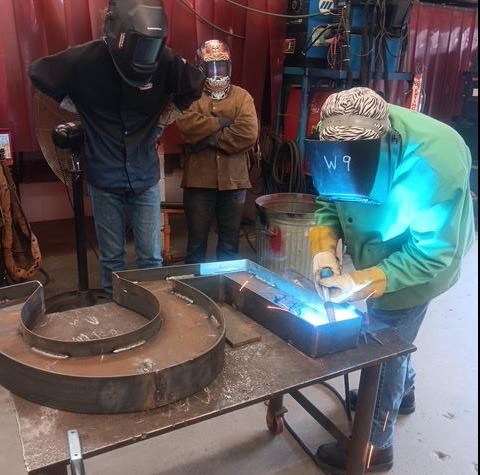 A student from Suffolk’s College and Career Academy at Pruden (CCAP) Welding the 757 Bike Rack
